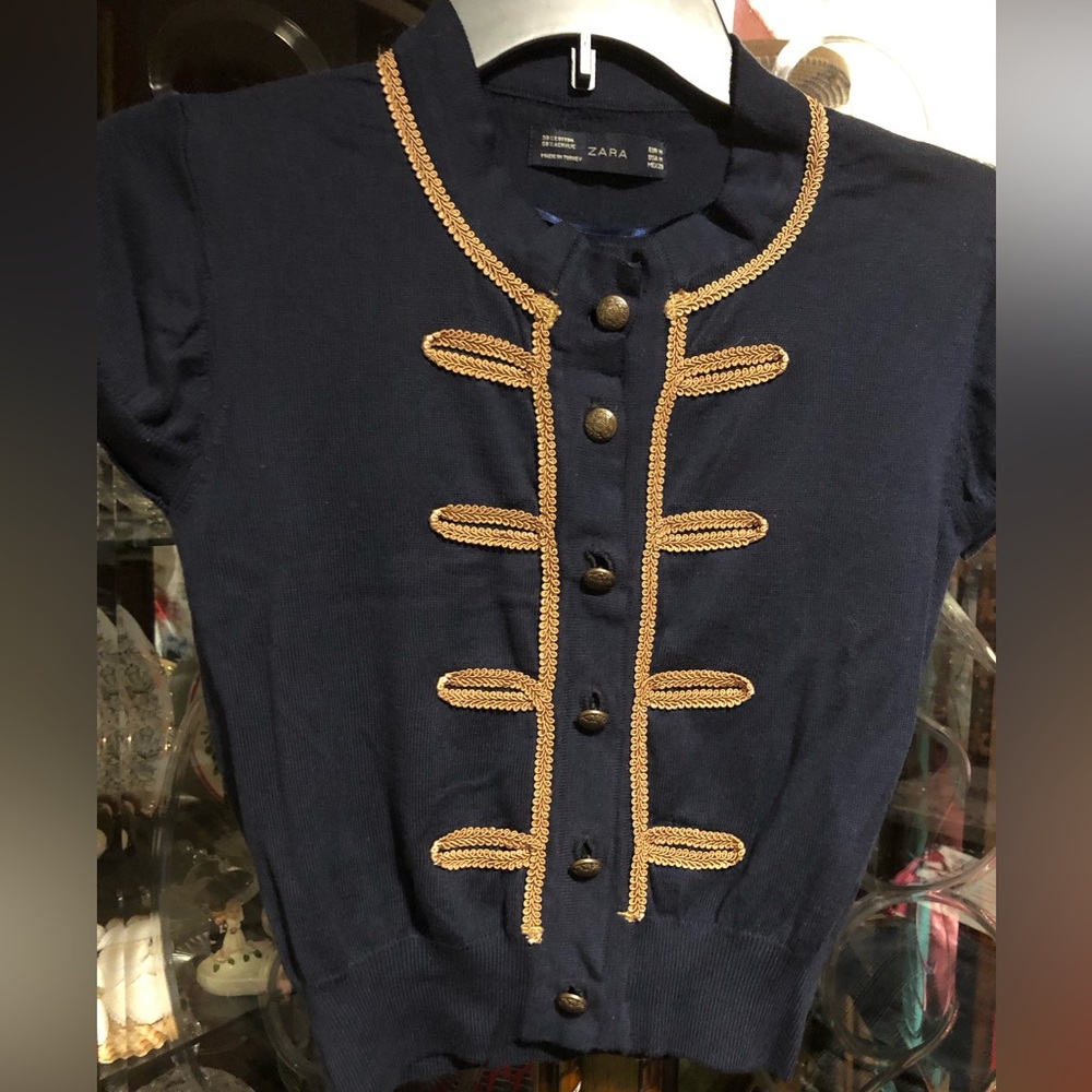 Zara - A Navy blue , it’s a light Knit Cardigan with Gold Braided Trim.